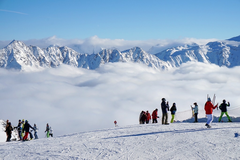 Skiers above clouds in Val d'Isère